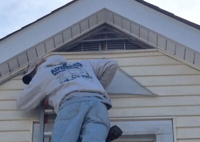 Male worker repairing the window